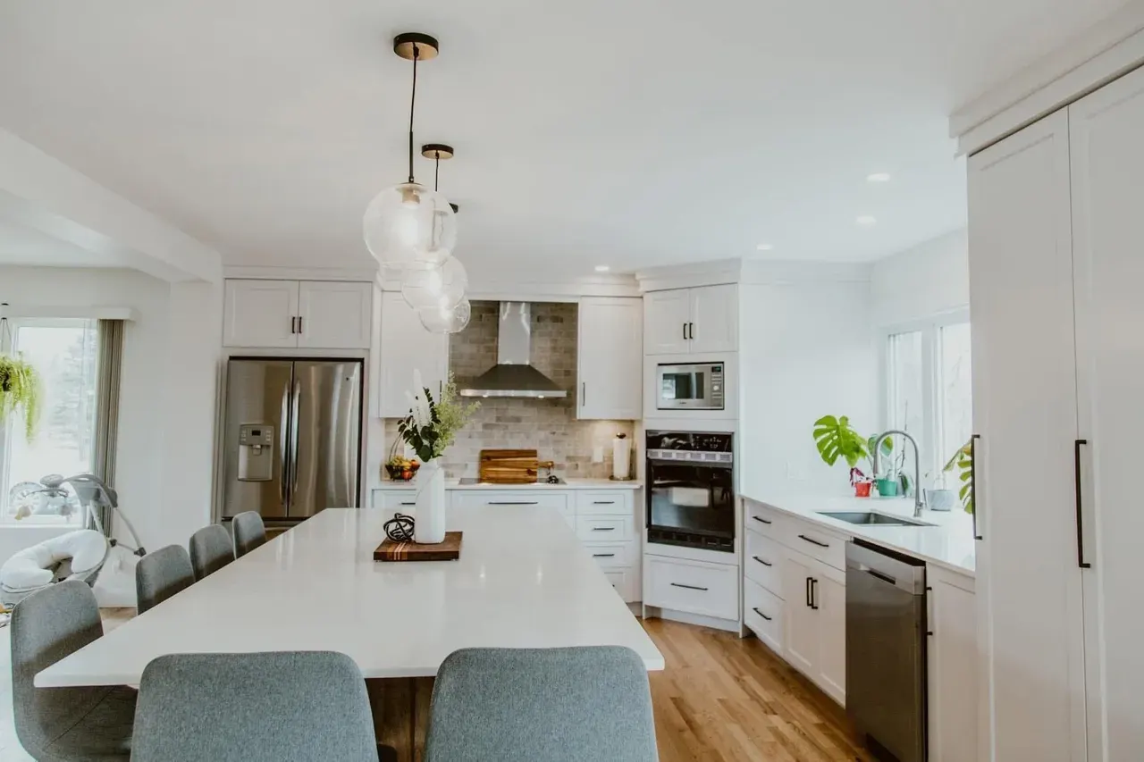 Long countertop island in a white kitchen