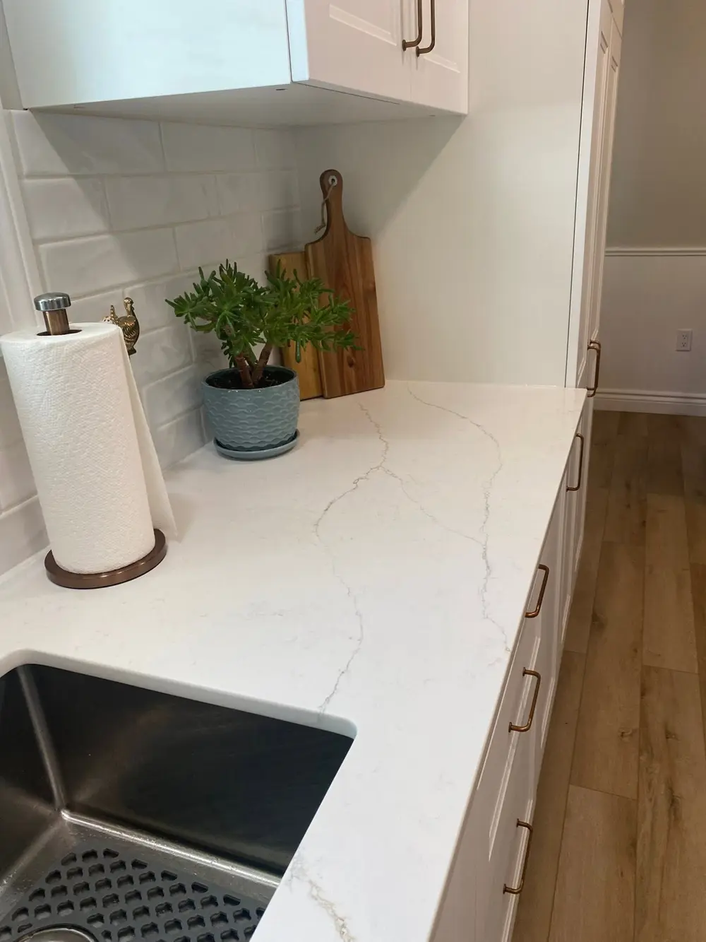 Close-up of a white veined countertop beside an undermount sink