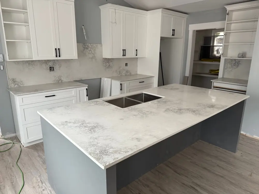 Grey and white patterned island with a double undermount sink