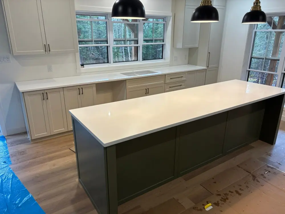 Countertops installed on a green island and white cabinets