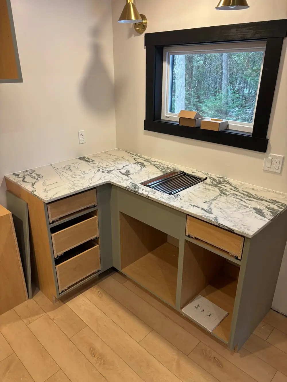 Green and white veined natural stone countertop with a sink cutout